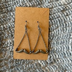 Dangly grey mustache earrings.